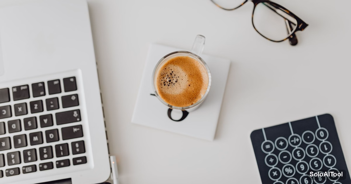 Top-down view of a white desk with a laptop, a cup of coffee, reading glasses and a calculator